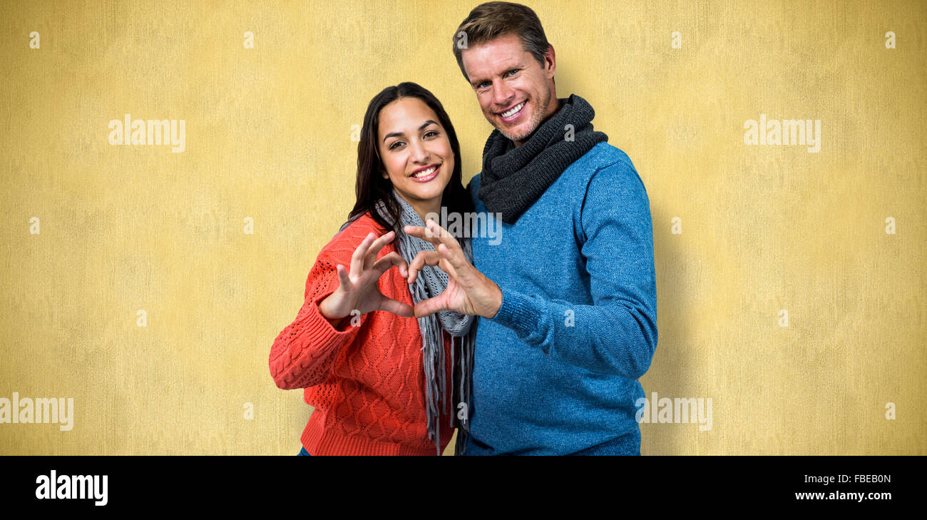 Composite image of portrait of couple making heart shape with hands ...