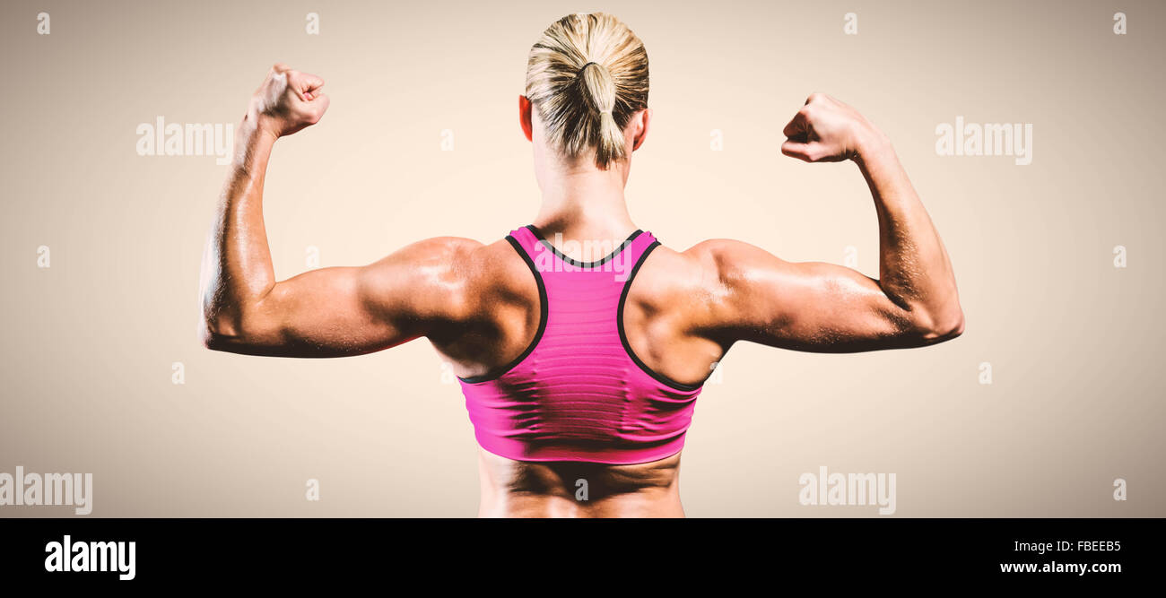 Strong muscular woman flexing his arms. Fit and healthy woman on