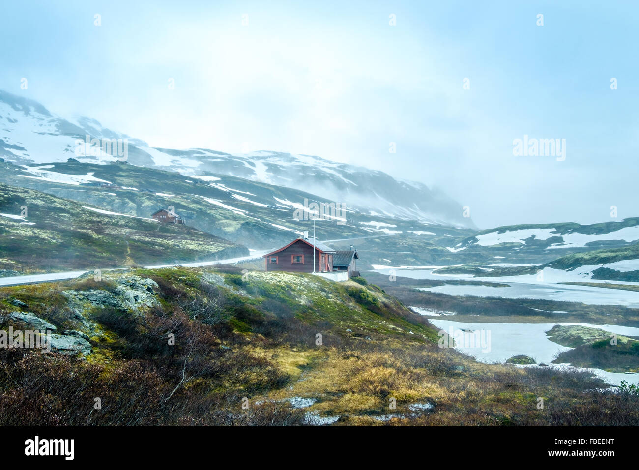 Norway landscape, a small village in inclement weather snowstorm and fog in the mountains. Beautiful Nature Norway. Stock Photo