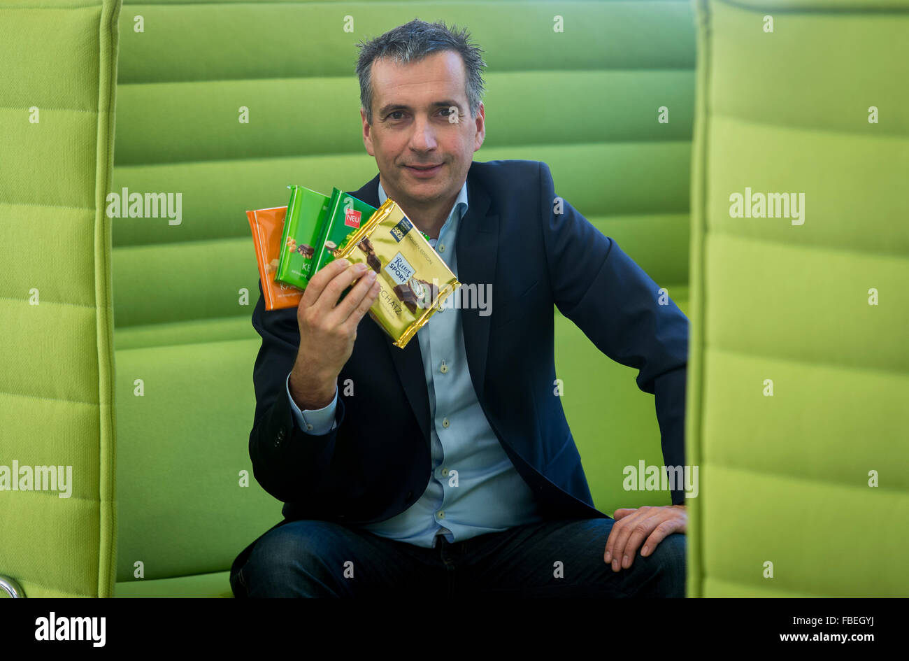 Chairman of the management board of chocolate manufacturer Ritter Sport, Andreas Ronken, holds chocolate bars with different flavours in his hand at the company headquarter in Waldenbuch, Germany, 8 December 2015. Photo: Daniel Maurer/dpa Stock Photo