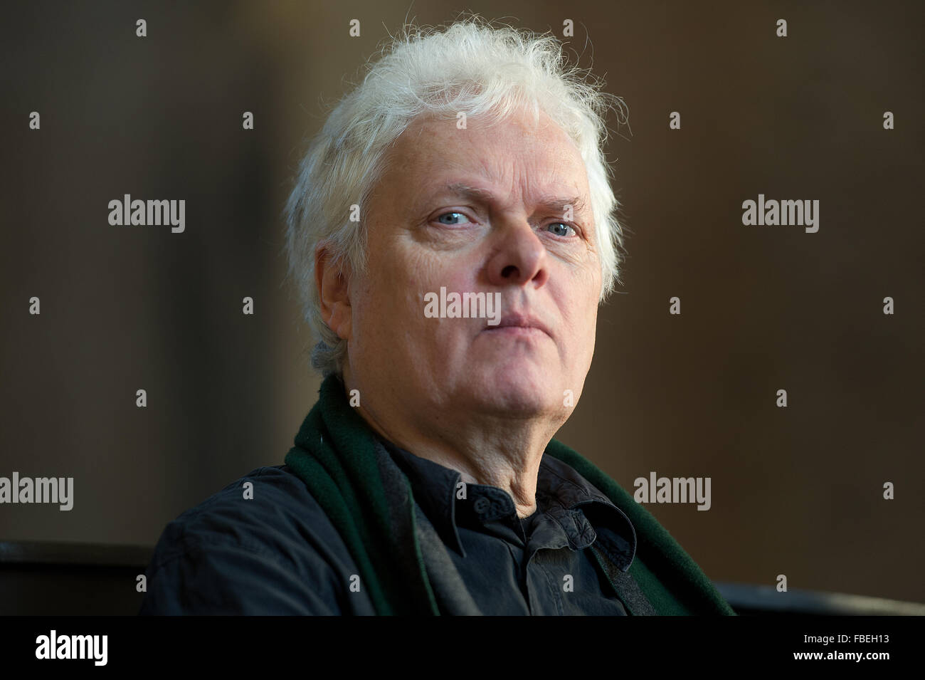 Composer and director Heiner Goebbels during the presentation of his multimedia installation 'Die Provinz des Menschen/The Human Province' in the Kunsthalle im Lipsiusbau in Dresden, Germany, 14 January 2016. The installation is made up of 54 different film sequences, played on a giant wall of monitors, together forming a composition that explores polyphony both as a musical and visual phenomenon and that presents an urban soundscape of various cities, criss-crossed by actor André Wilms. Visitors watch the same man observing the same rituals over the course of ten years, between 2004 and 201 Stock Photo