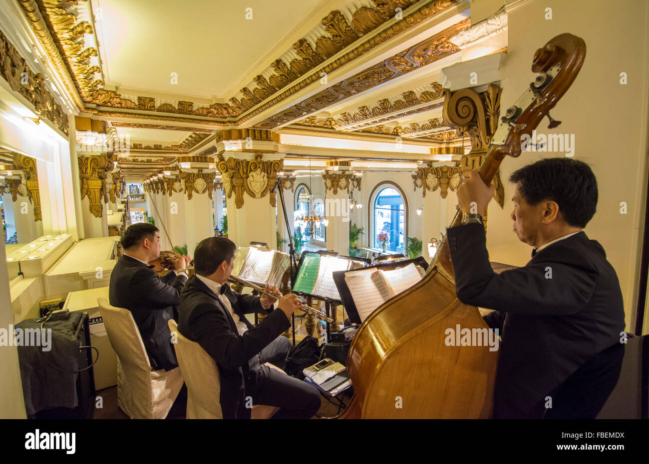 Hong Kong China  Peninsula Hotel orchestra playing at high tea in exclusive hotel from above lobby with music Stock Photo