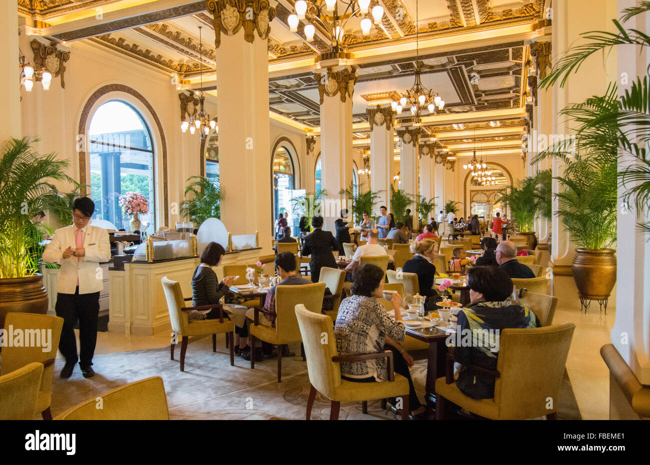 Hong Kong China  Peninsula Hotel high tea in lobby of exclusive hotel busy expensive Stock Photo