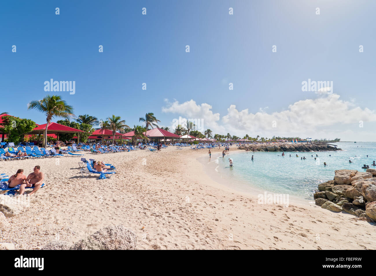 Tourists enjoy a sunny day on the sandy beach Stock Photo