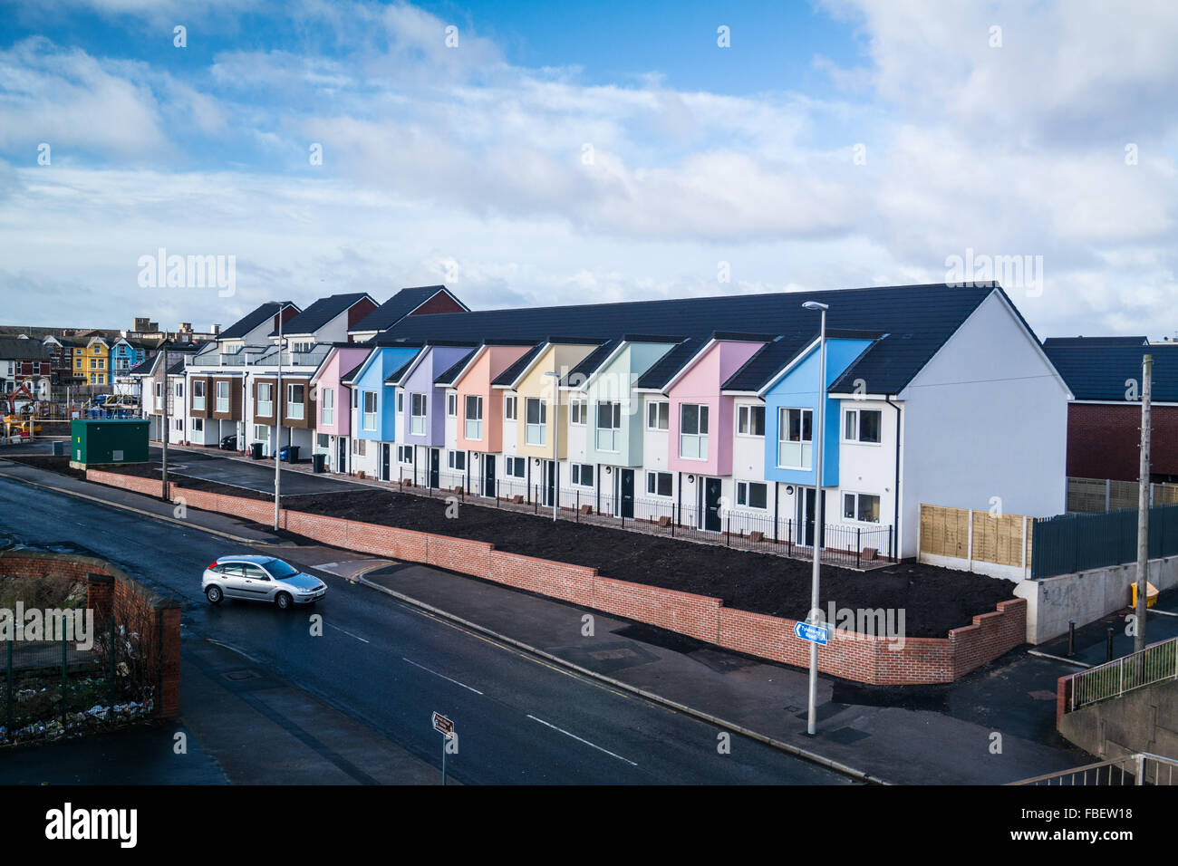 Colourful row of new built terraced housing Stock Photo