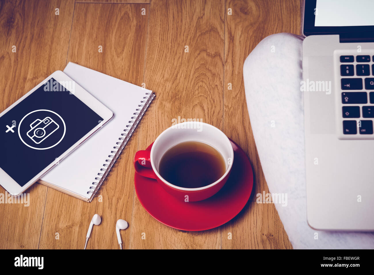 Composite image of overhead shot of laptop, tablet, coffee and headphones Stock Photo