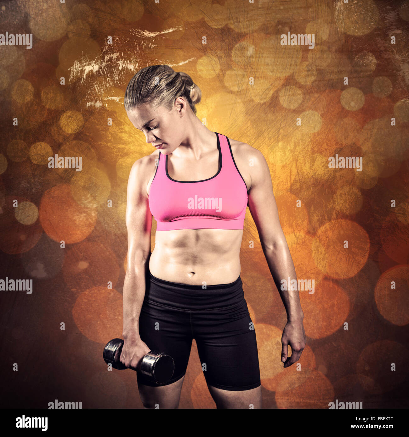 Composite image of muscular woman lifting heavy dumbbell Stock Photo