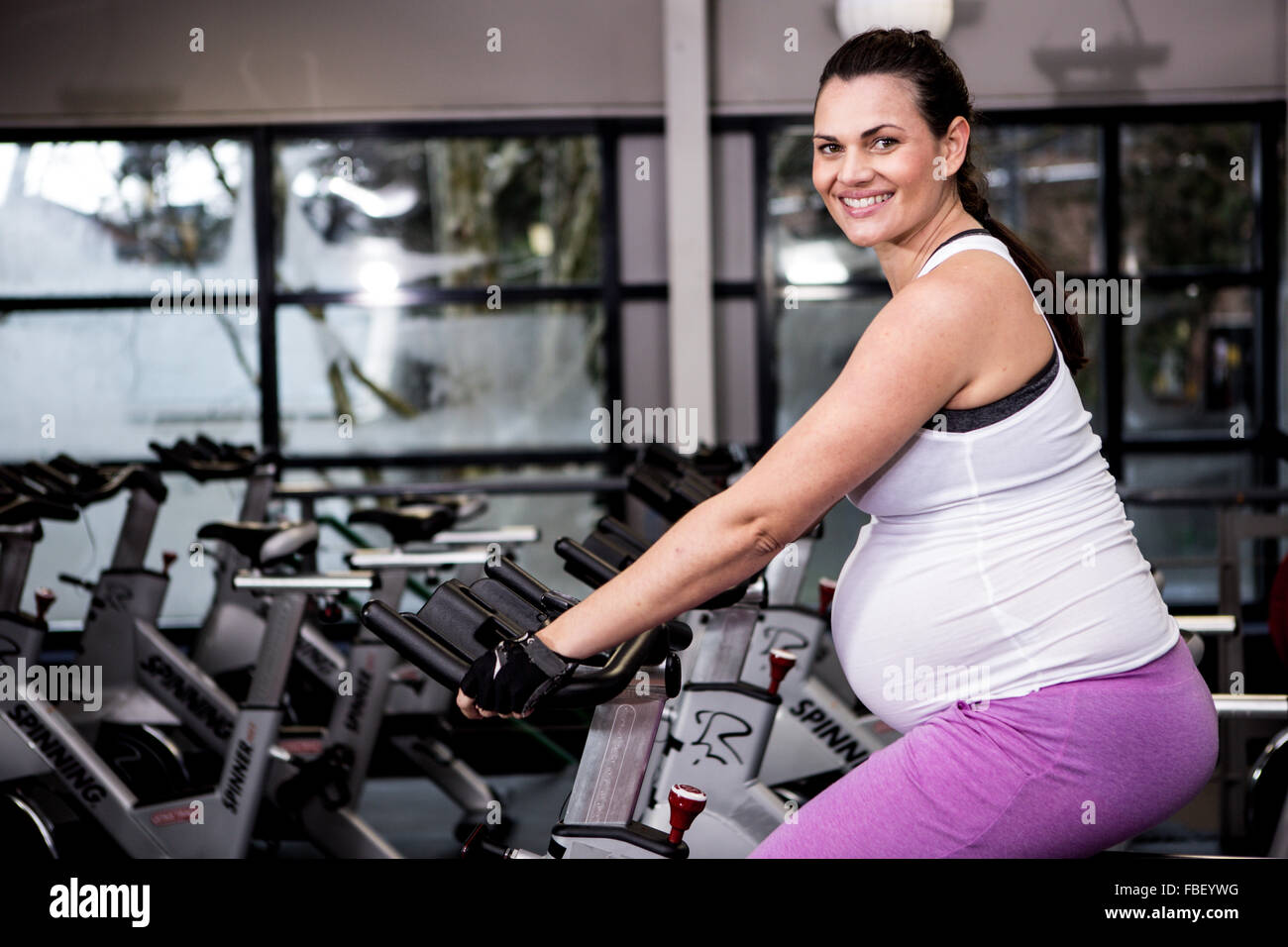Pregnant woman riding bike Stock Photo Alamy