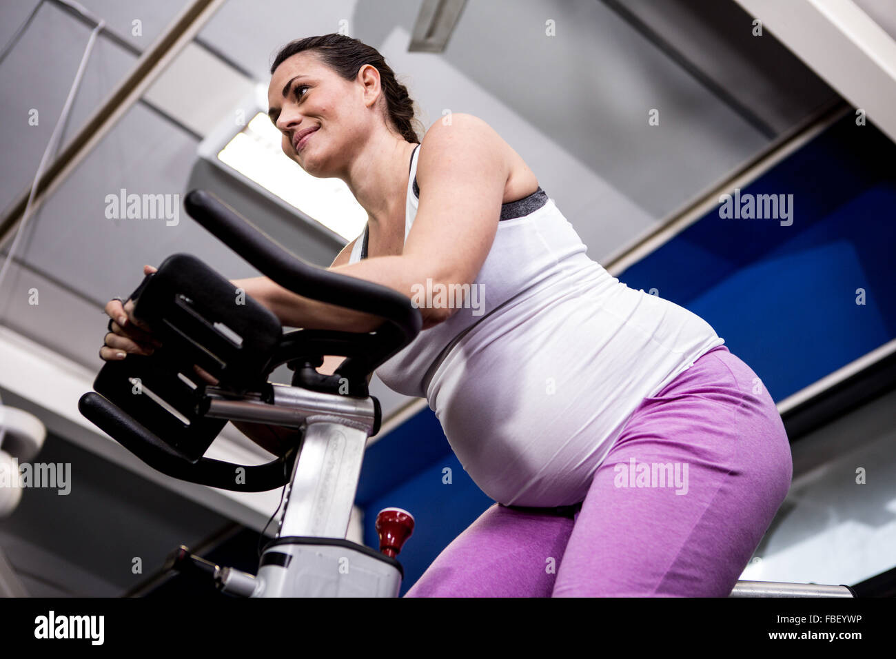Pregnant woman riding bike Stock Photo Alamy