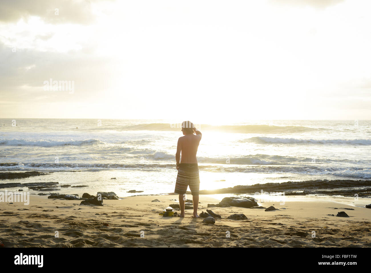 Men watching the sunset at Maria's Beach. Rincon, Puerto Rico. USA territory. Caribbean Island. Stock Photo