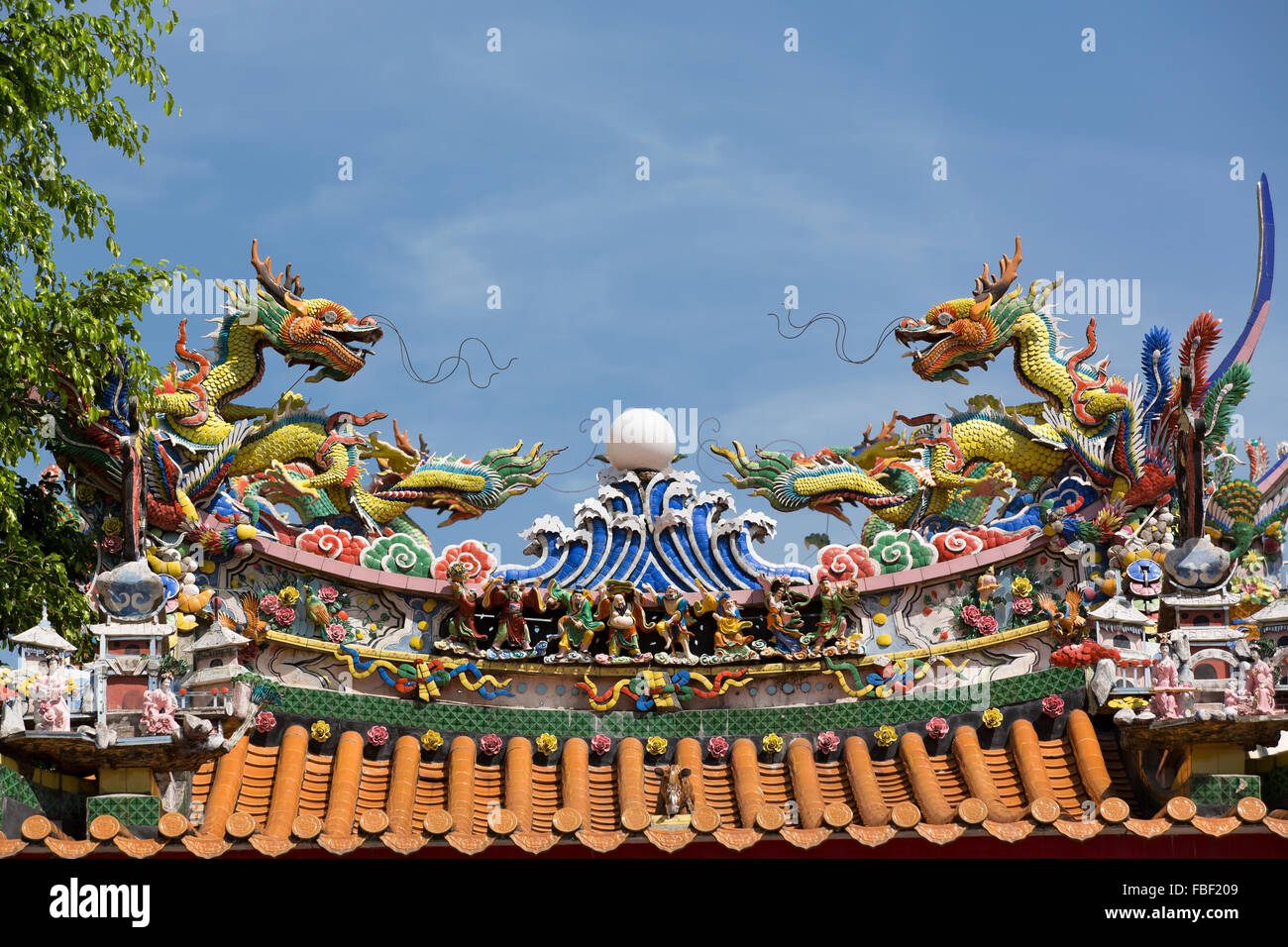 Colourful and ornate temple roof decorated with water dragons. Stock Photo