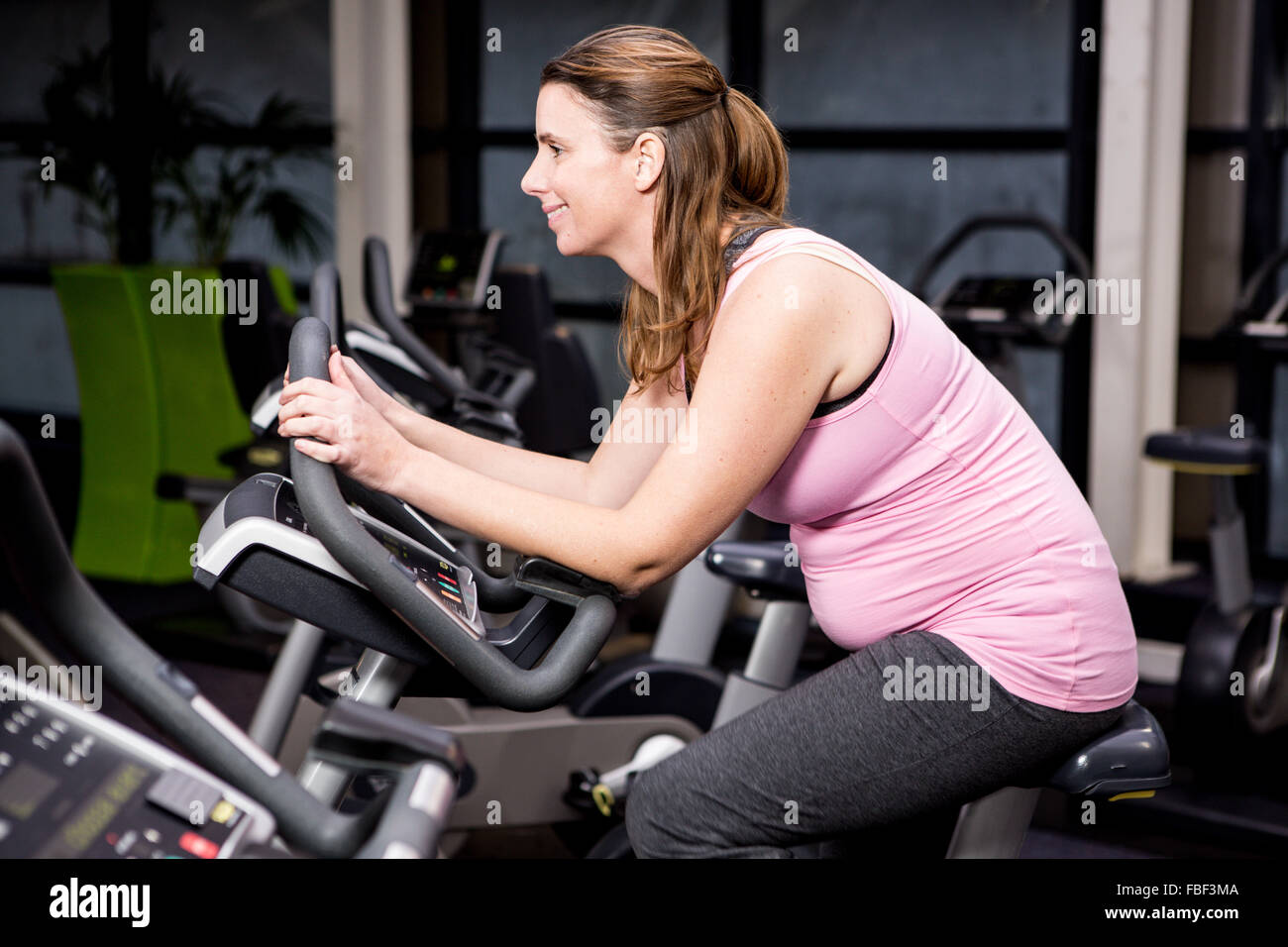 Pregnant woman riding bike Stock Photo Alamy
