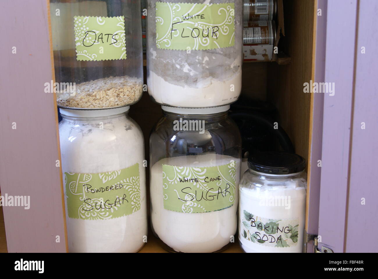 Labeled Food Storage Glass Jars In A Kitchen Cabinet Or Pantry