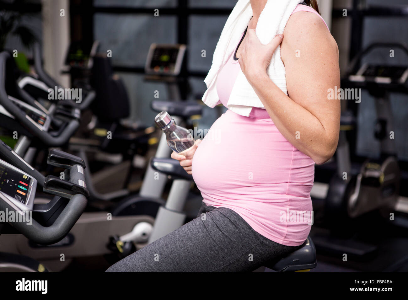 Pregnant woman riding bike Stock Photo Alamy