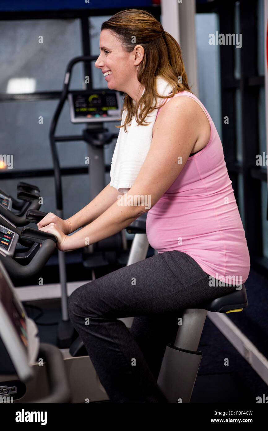 Pregnant woman riding bike Stock Photo Alamy