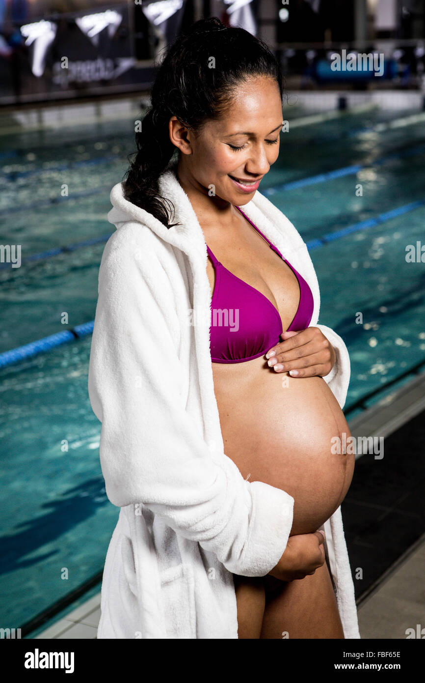Pregnant woman touching her belly Stock Photo