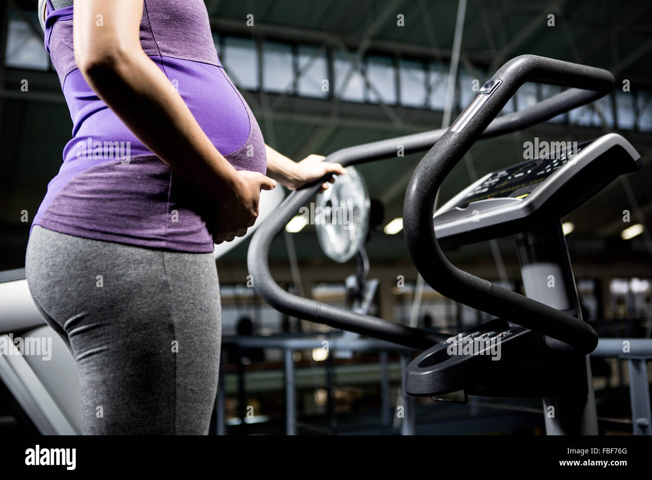 Pregnant woman standing on treadmill Stock Photo Alamy