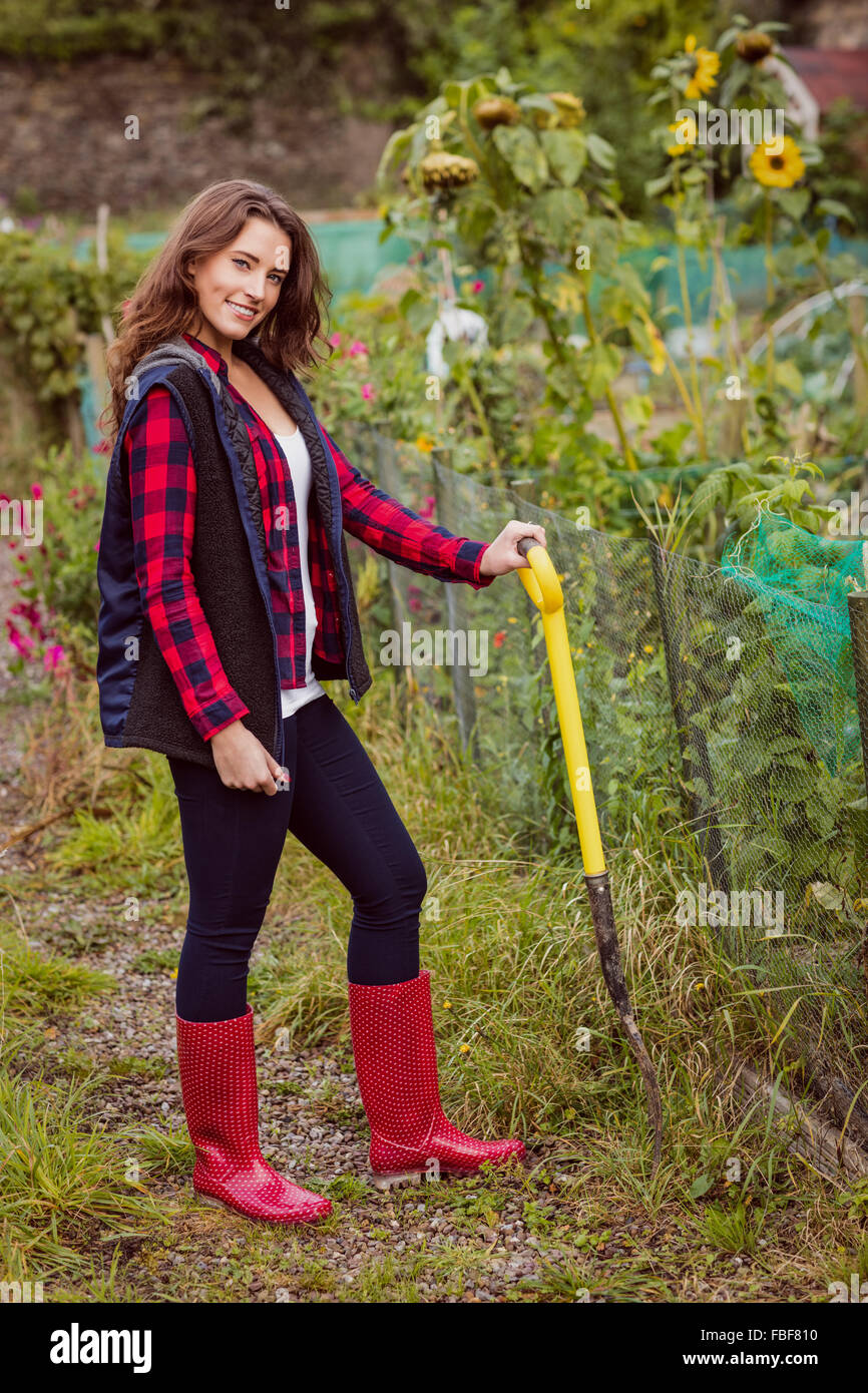 Smiling woman posing with a shovel Stock Photo - Alamy