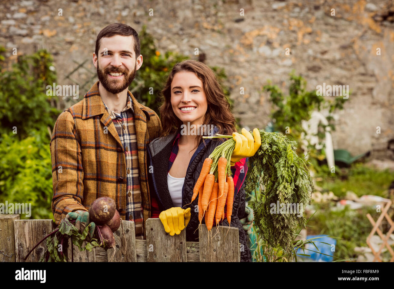Young couple holding vegetables Stock Photo - Alamy