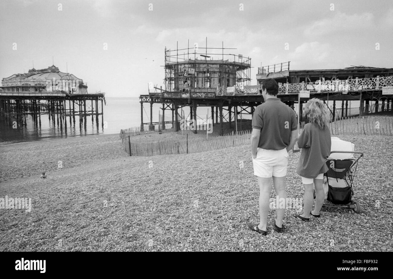 A couple look at the nowderelict West Pier on Brighton beach in 1989