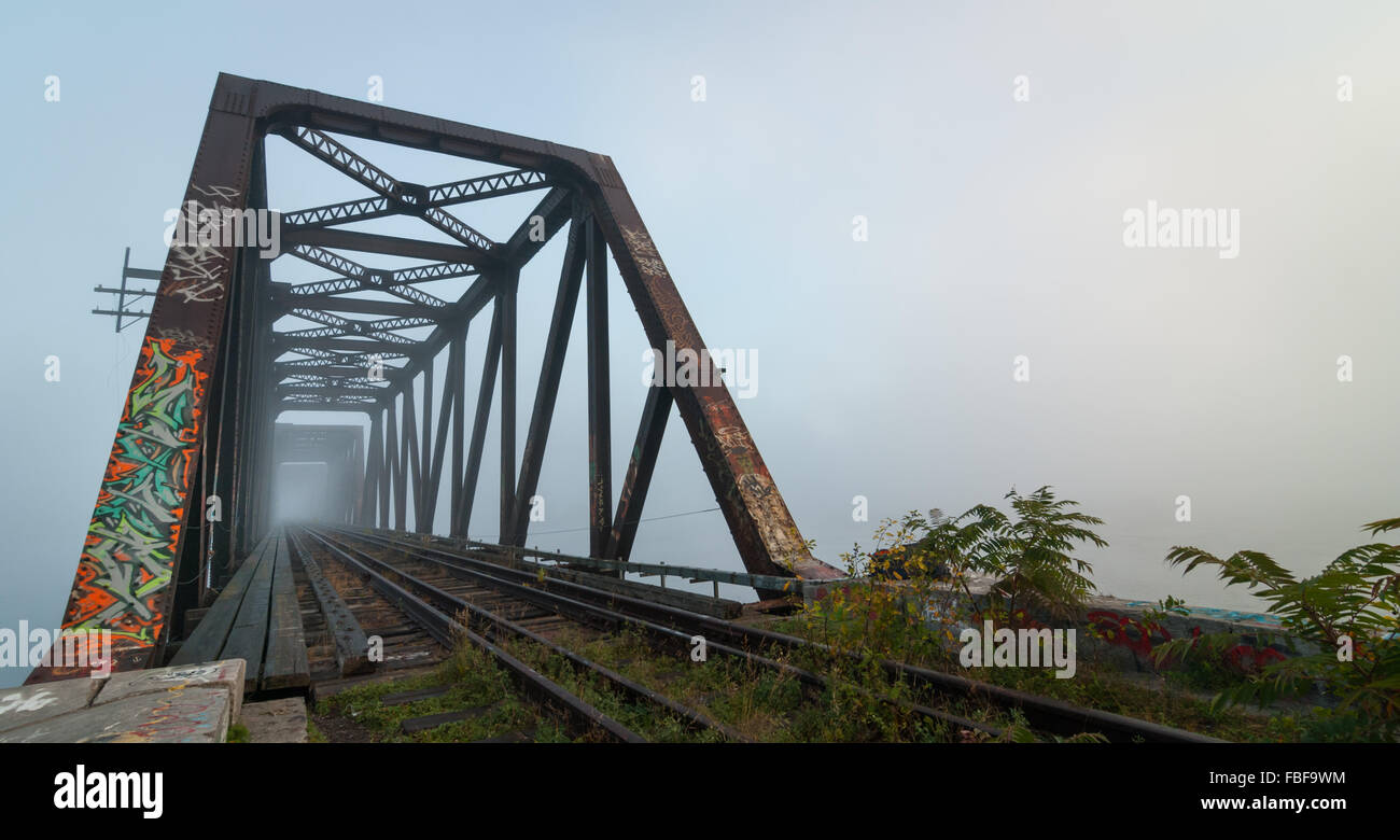 Foggy morning railway bridge. Stock Photo