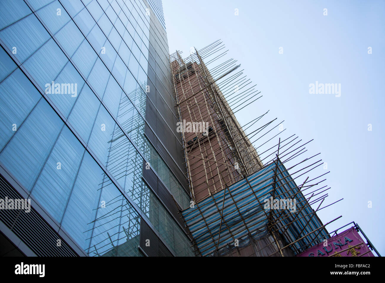 Bamboo scaffoldings and modern skyscraper glass building in Hong-Kong Stock Photo