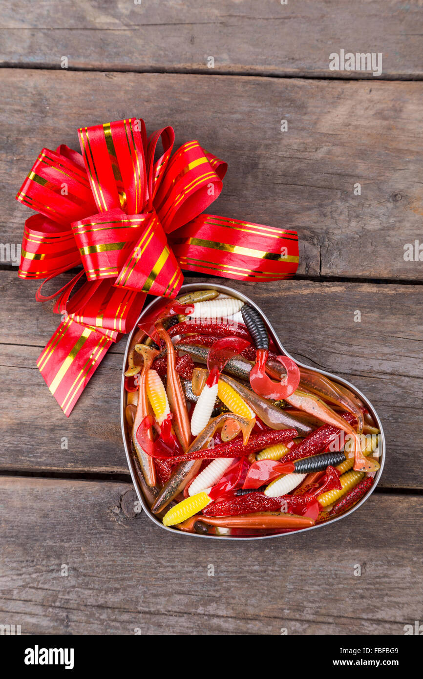 fishing softbaits in gift box of heart with bow for valentines day.  surprise for romantic fishers Stock Photo - Alamy
