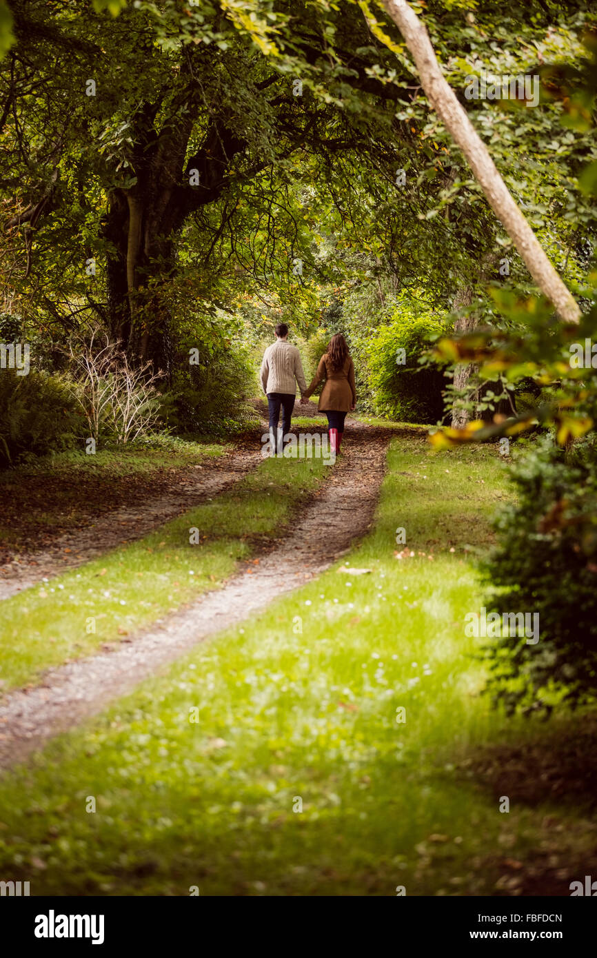 Couple holding hand while walking Stock Photo - Alamy