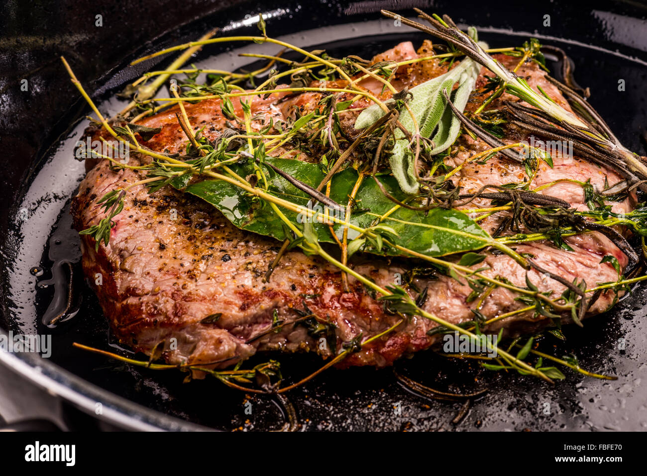 Beef steak with herbes of Provence fried in the pan, fat, fry, roast, meat, best, best, well done, raw, bloody well done stylish Stock Photo