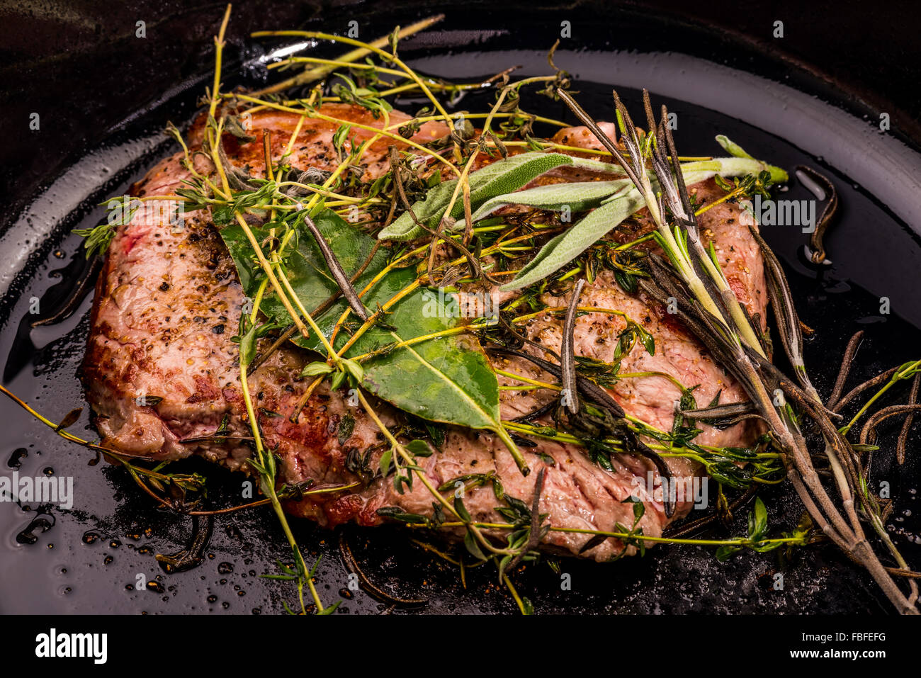 Beef steak with herbes of Provence fried in the pan, fat, fry, roast, meat, best, best, well done, raw, bloody well done stylish Stock Photo