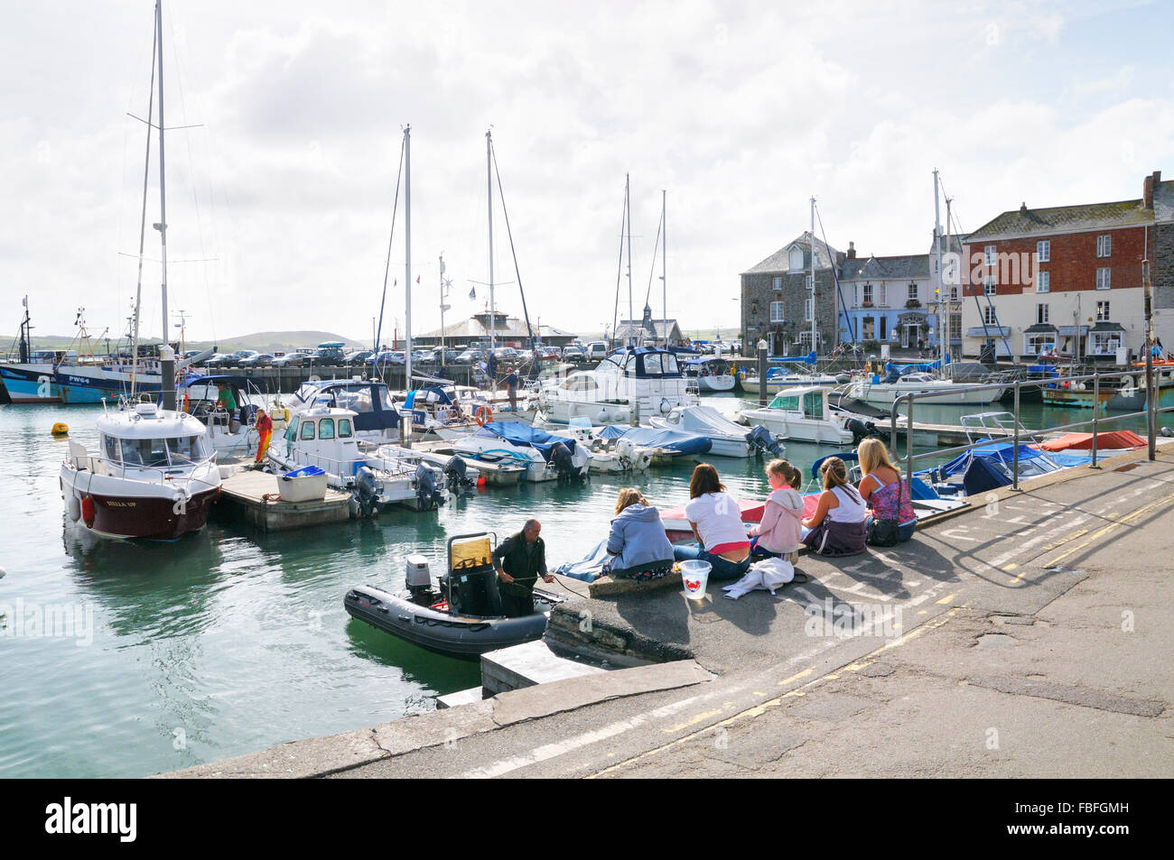 A family crab fishing on the quay at Padstow harbour, North Cornwall, England, UK Stock Photo