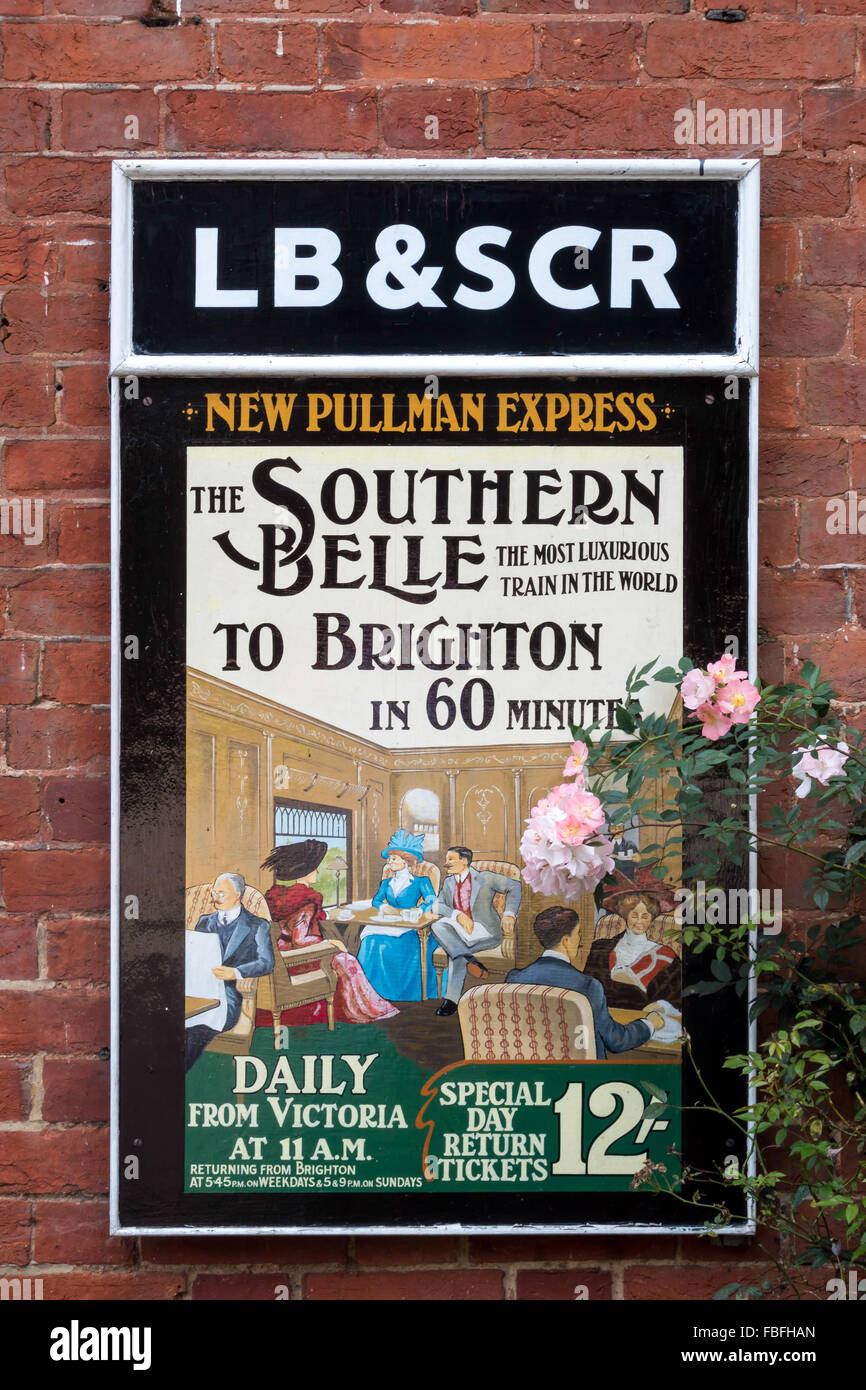 Old railway poster advertising The Southern Belle train at Sheffield Park Station Stock Photo