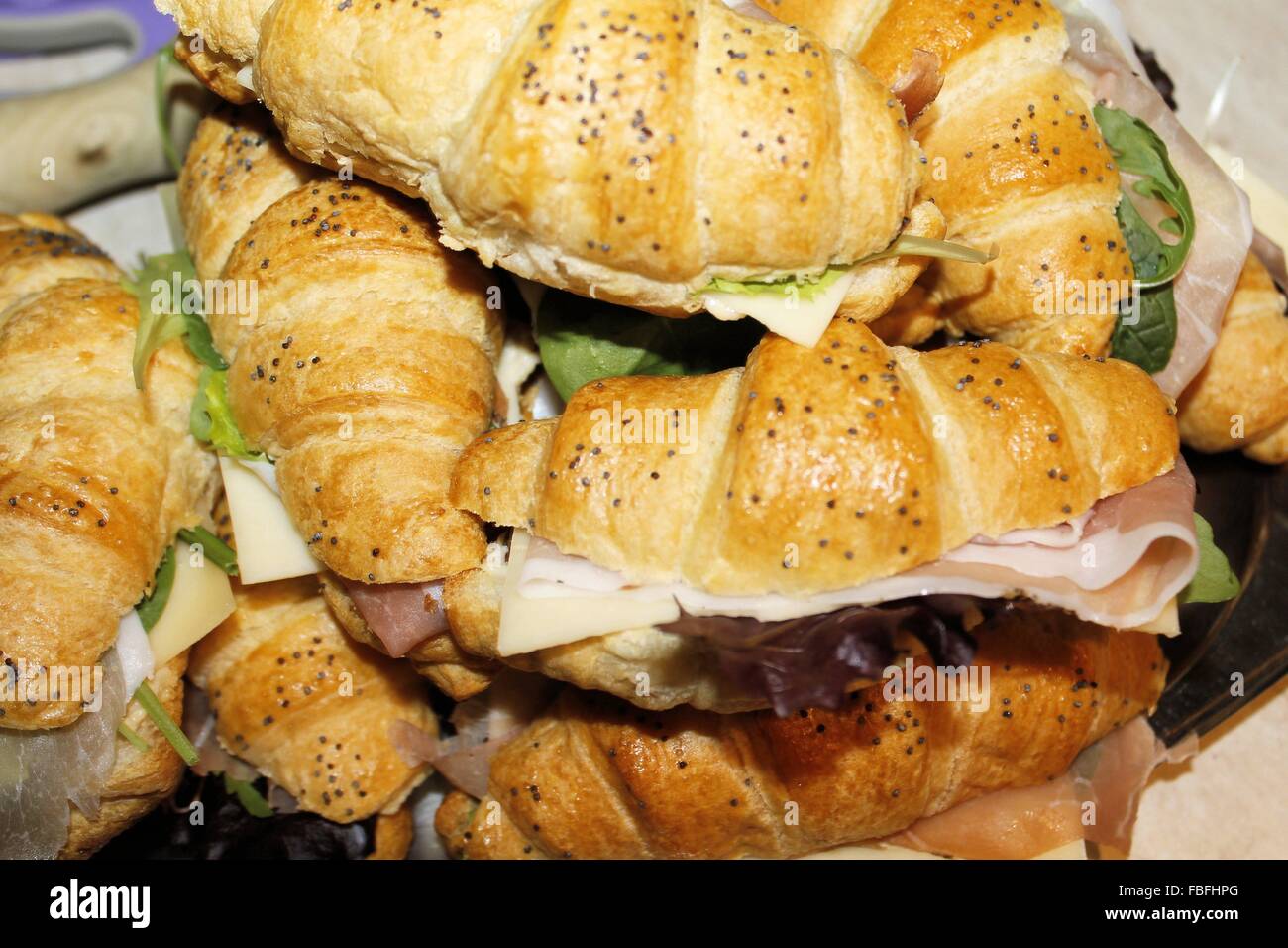 small sandwiches filled with ham, cheese and lettuce Stock Photo