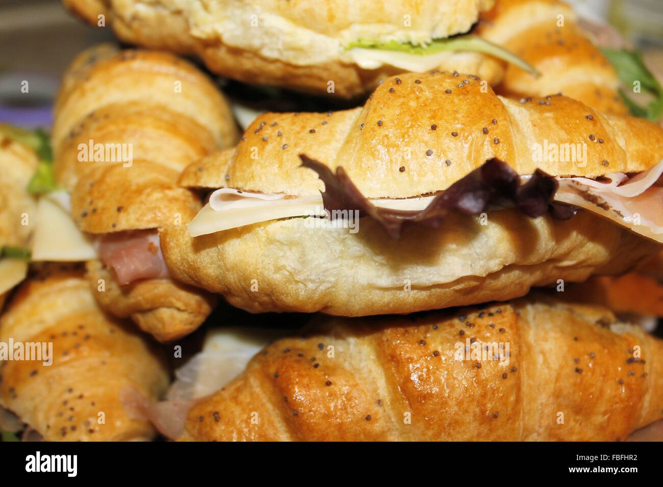 small sandwiches filled with ham, cheese and lettuce Stock Photo