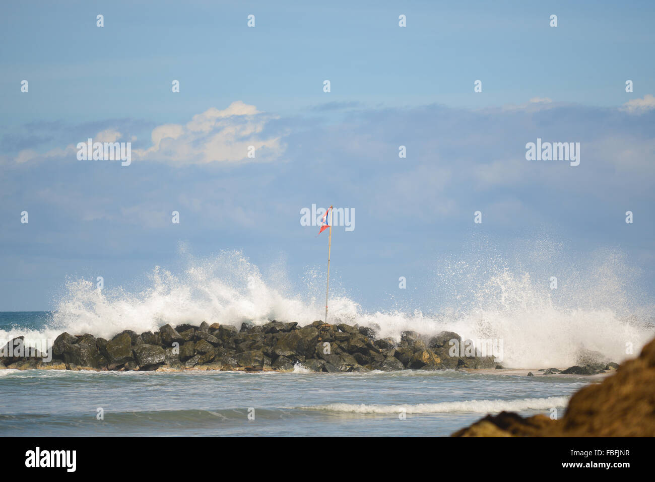 Puertorican flag and waves crashing at Dome's Beach. Rincon, Puerto Rico. USA territory. Caribbean Island. Stock Photo