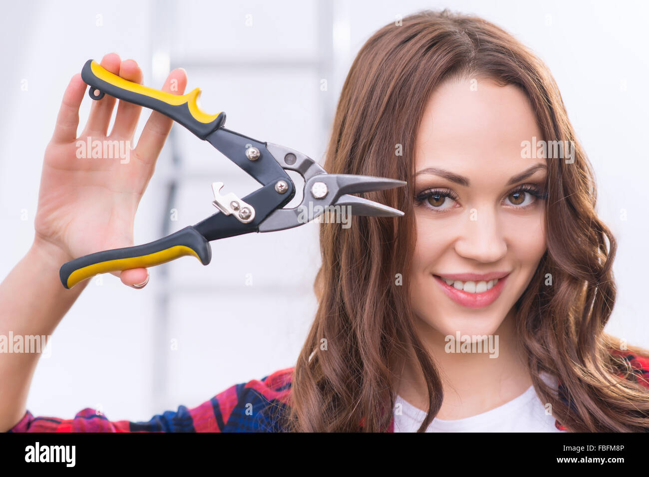 Attractive girl is showing pliers Stock Photo Alamy
