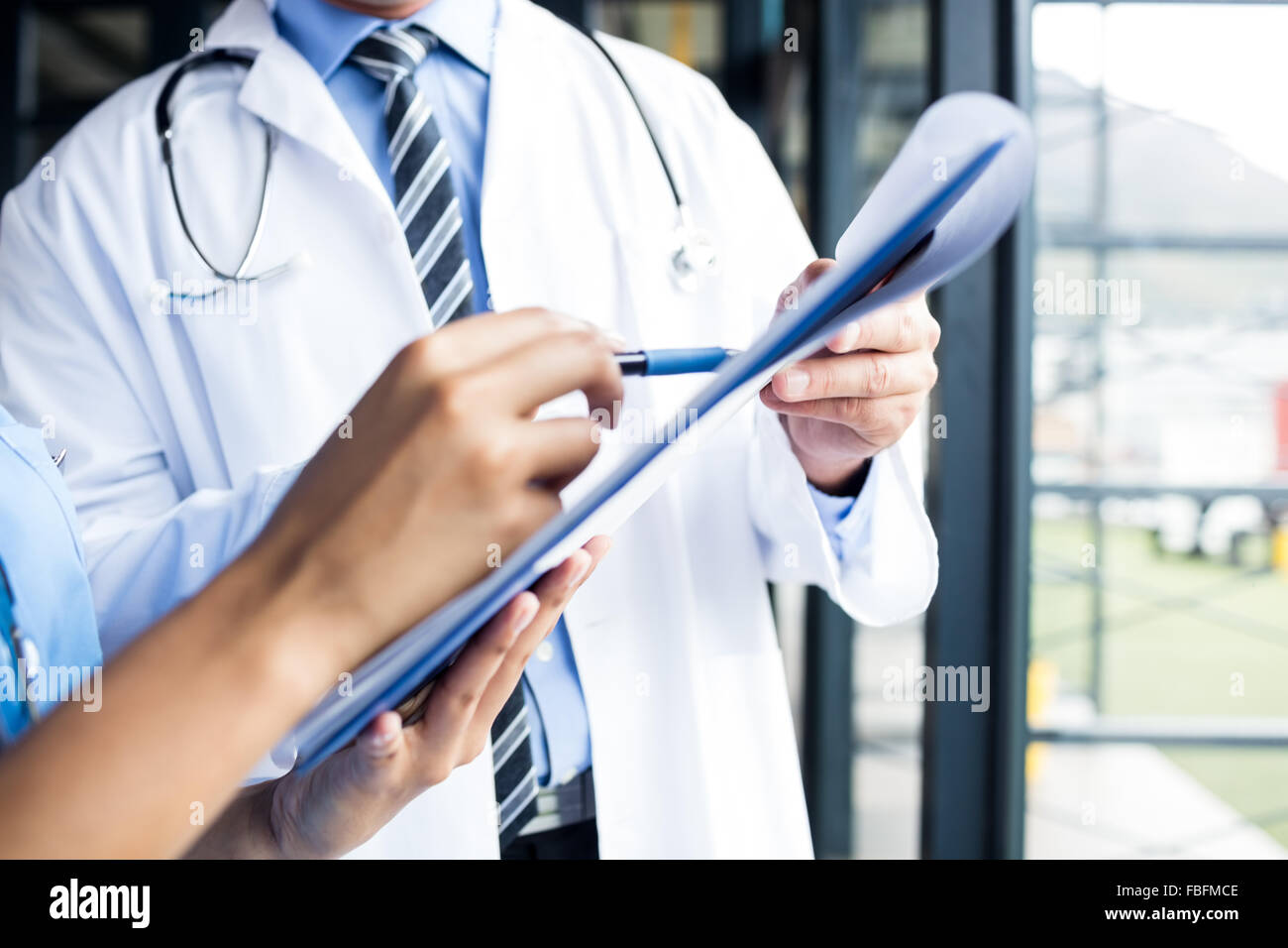 Nurse and doctor looking at files Stock Photo