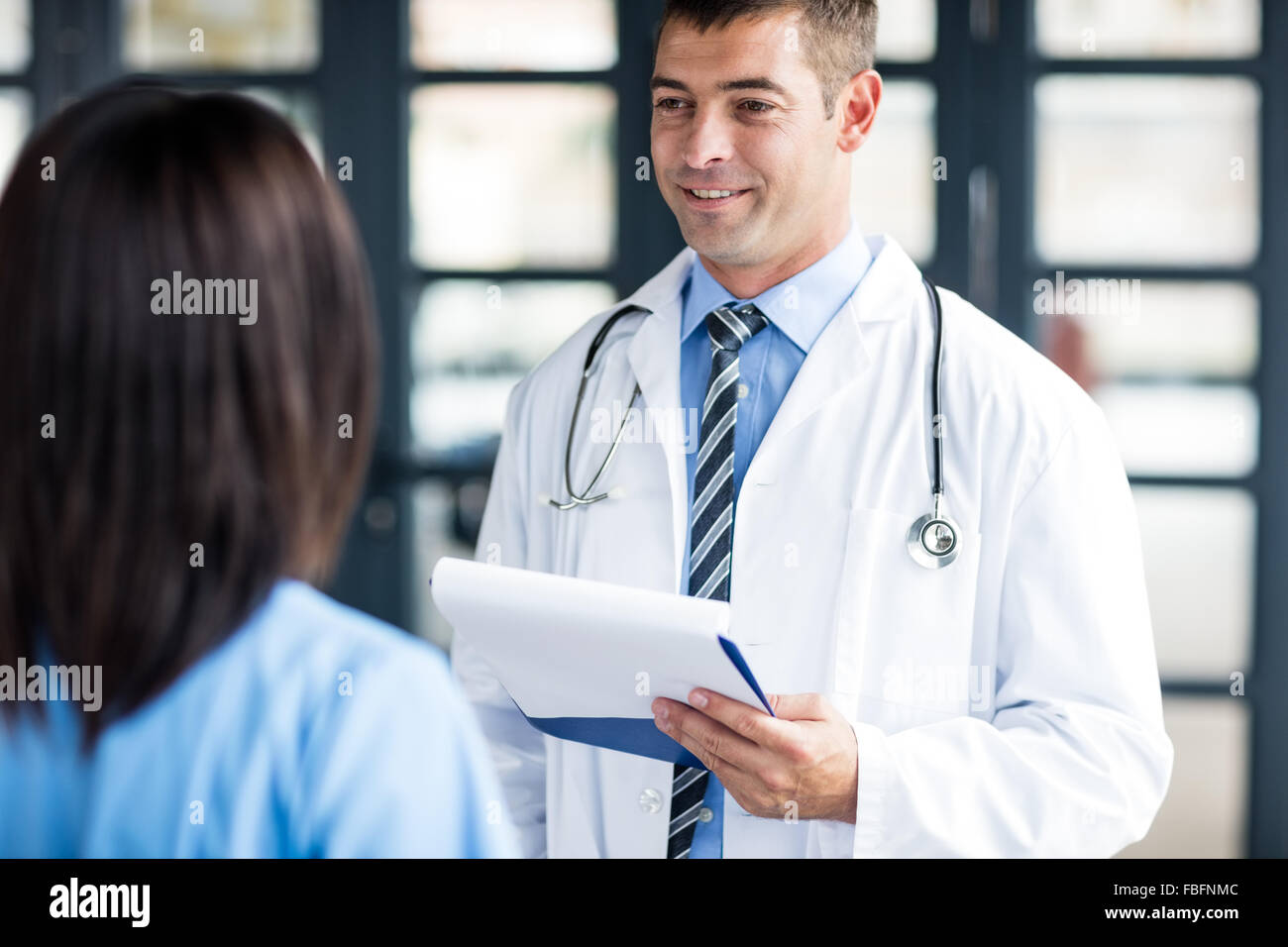 Smiling nurse talking doctor hi-res stock photography and images - Alamy