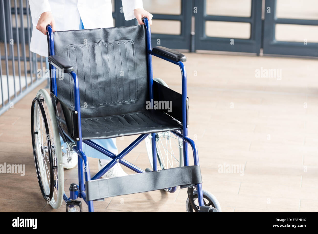 Doctor showing a wheelchair Stock Photo