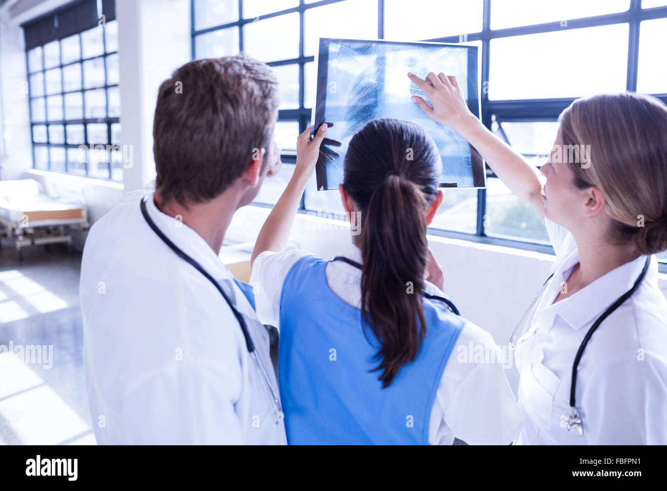 Medical team looking at x-ray together Stock Photo