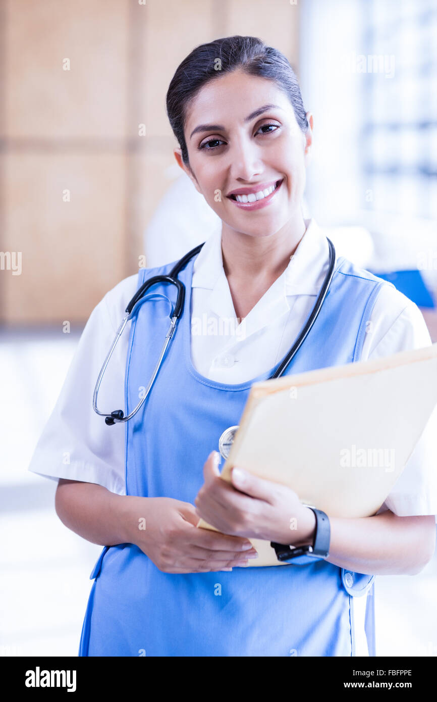 Smiling nurse holding report on clipboard Stock Photo Alamy