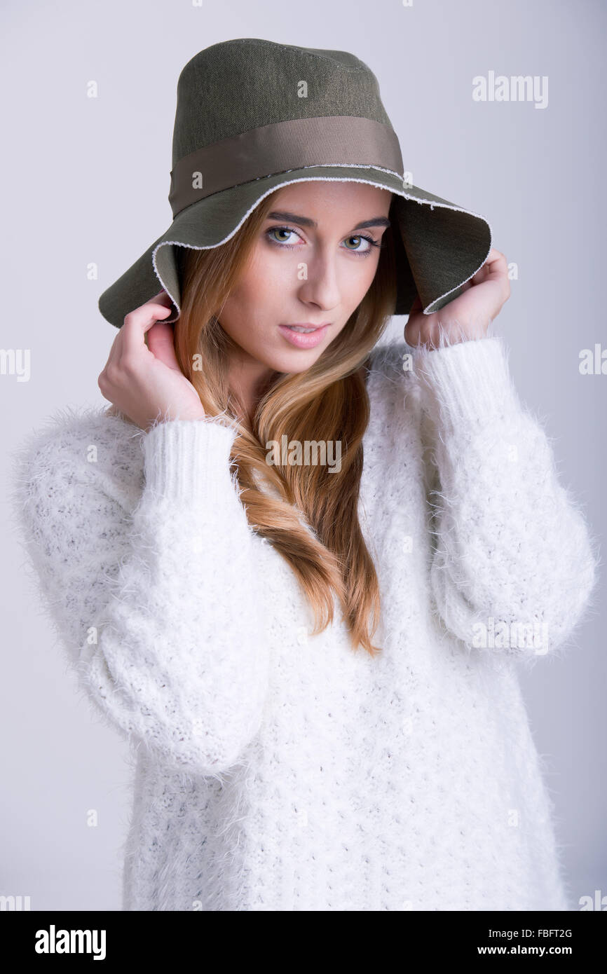 Female model posing with a hat in the studio Stock Photo