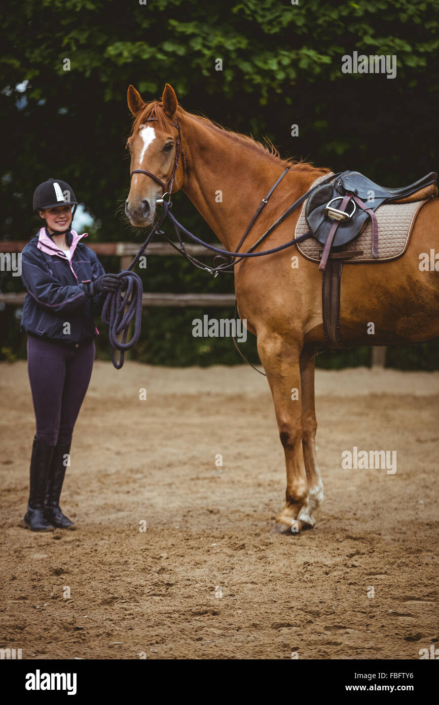 Female rider leading her horse Stock Photo - Alamy