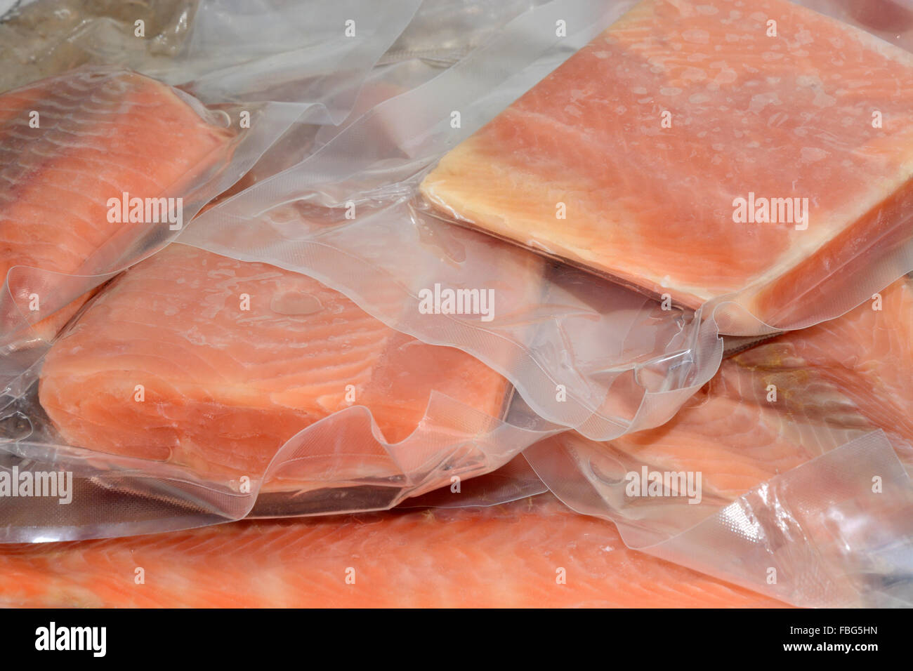 Frozen salmon fillets in vacuum packed plastic packaging Stock Photo