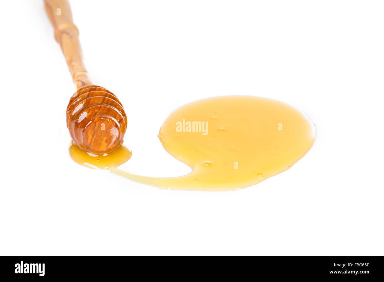 Spoon of honey on a white background Stock Photo - Alamy