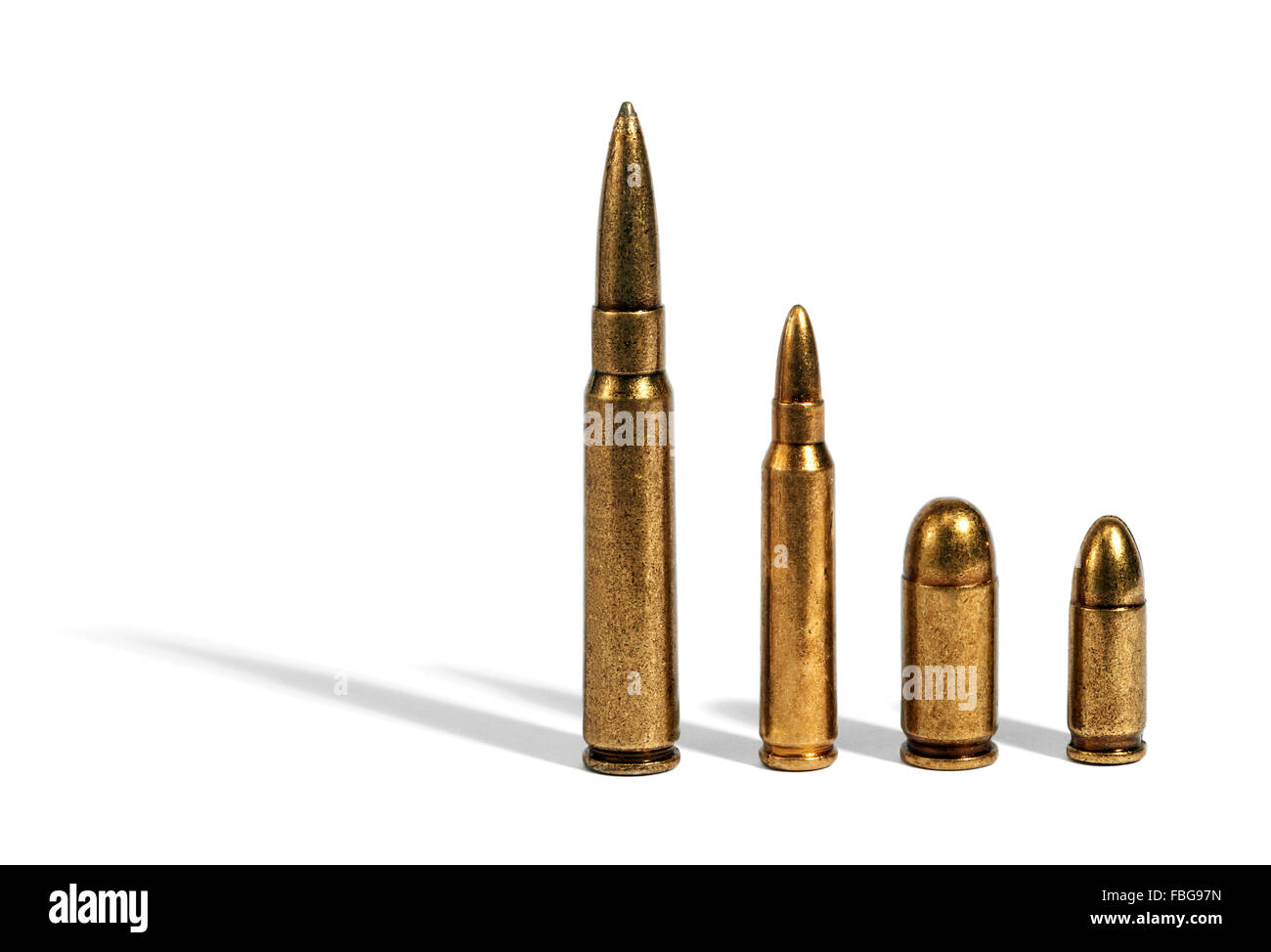 Four different sized bullets comparing ammunition over white background Stock Photo