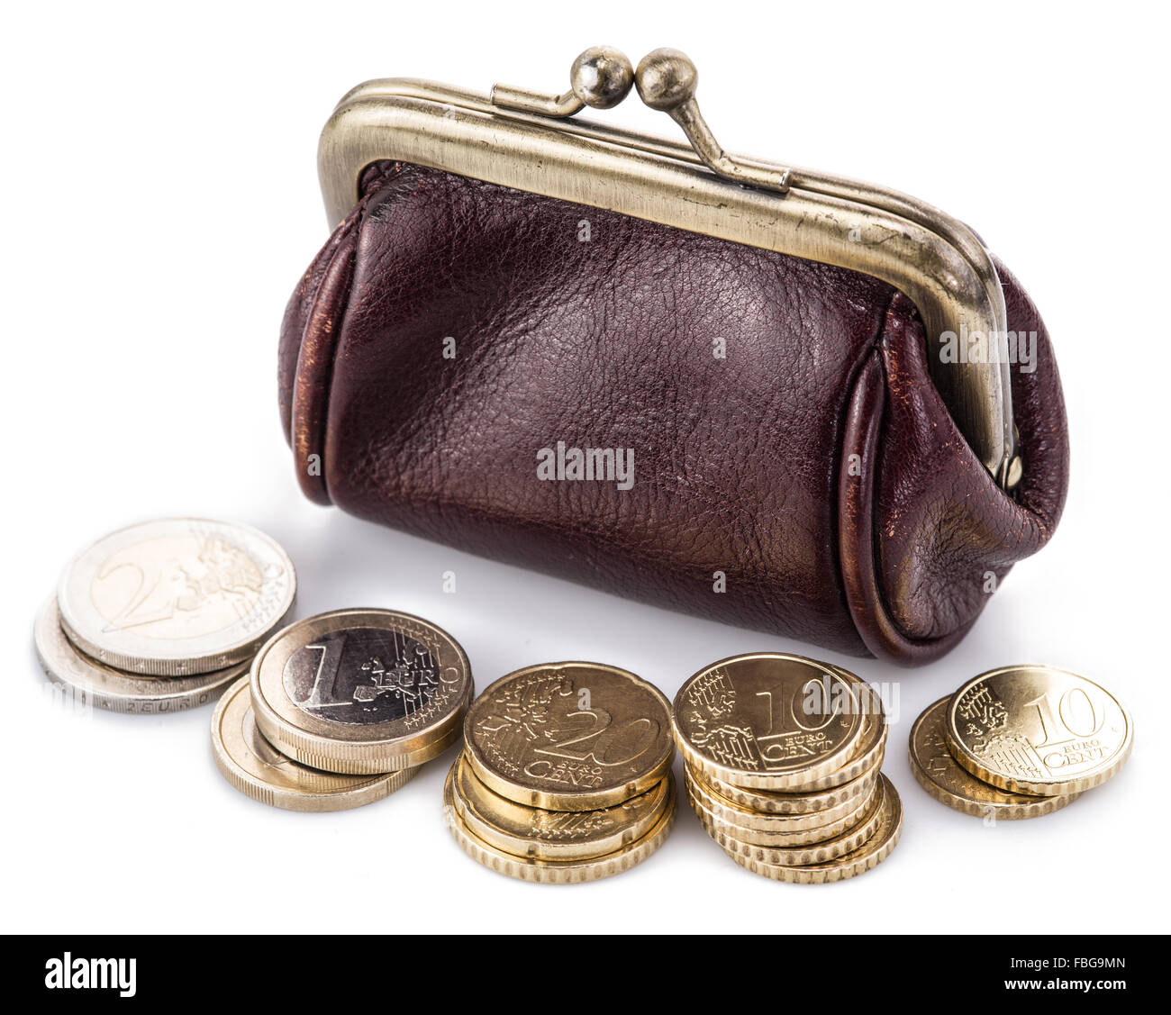 Small leather purse for coins and coins near it. Isolated on white background. Stock Photo