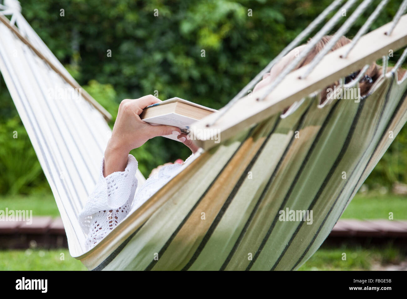 Woman relaxing in hammock Stock Photo - Alamy