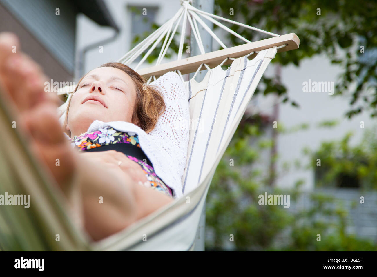 Woman relaxing in hammock Stock Photo - Alamy