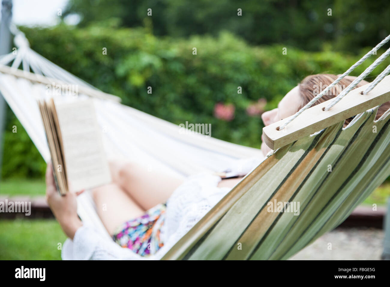 Woman relaxing in hammock Stock Photo - Alamy
